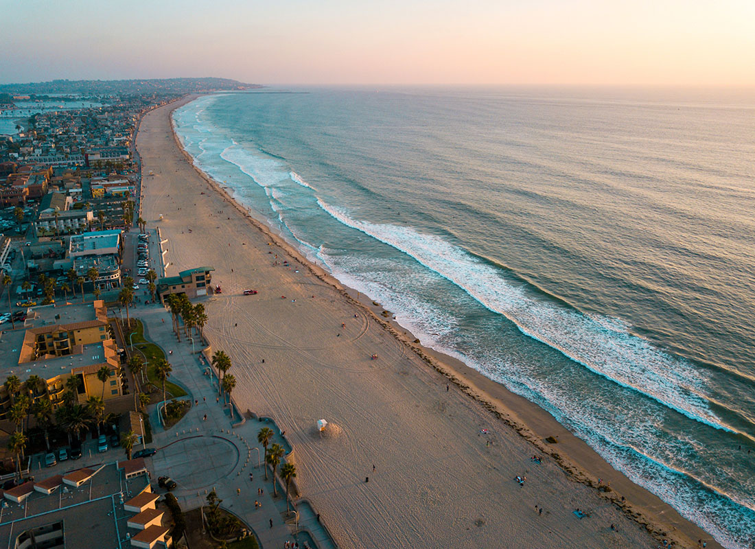 We Are Independent - Aerial View of Commercial and Residential Buildings Along the Beach in San Diego California at Sunset